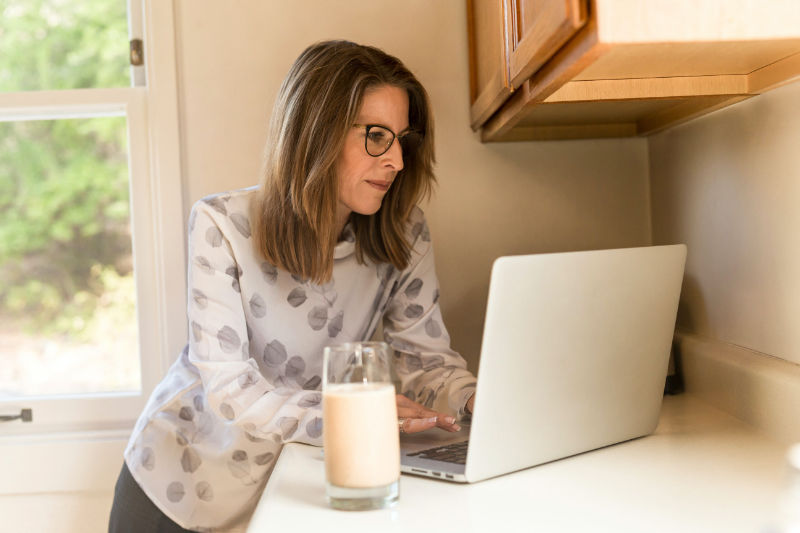 woman on laptop looking up retirement